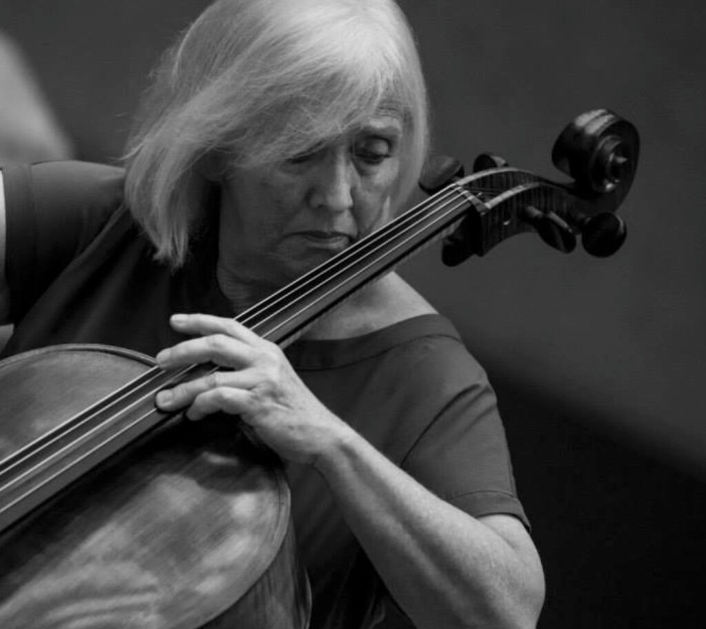 Judith Glyde playing cello in Italy